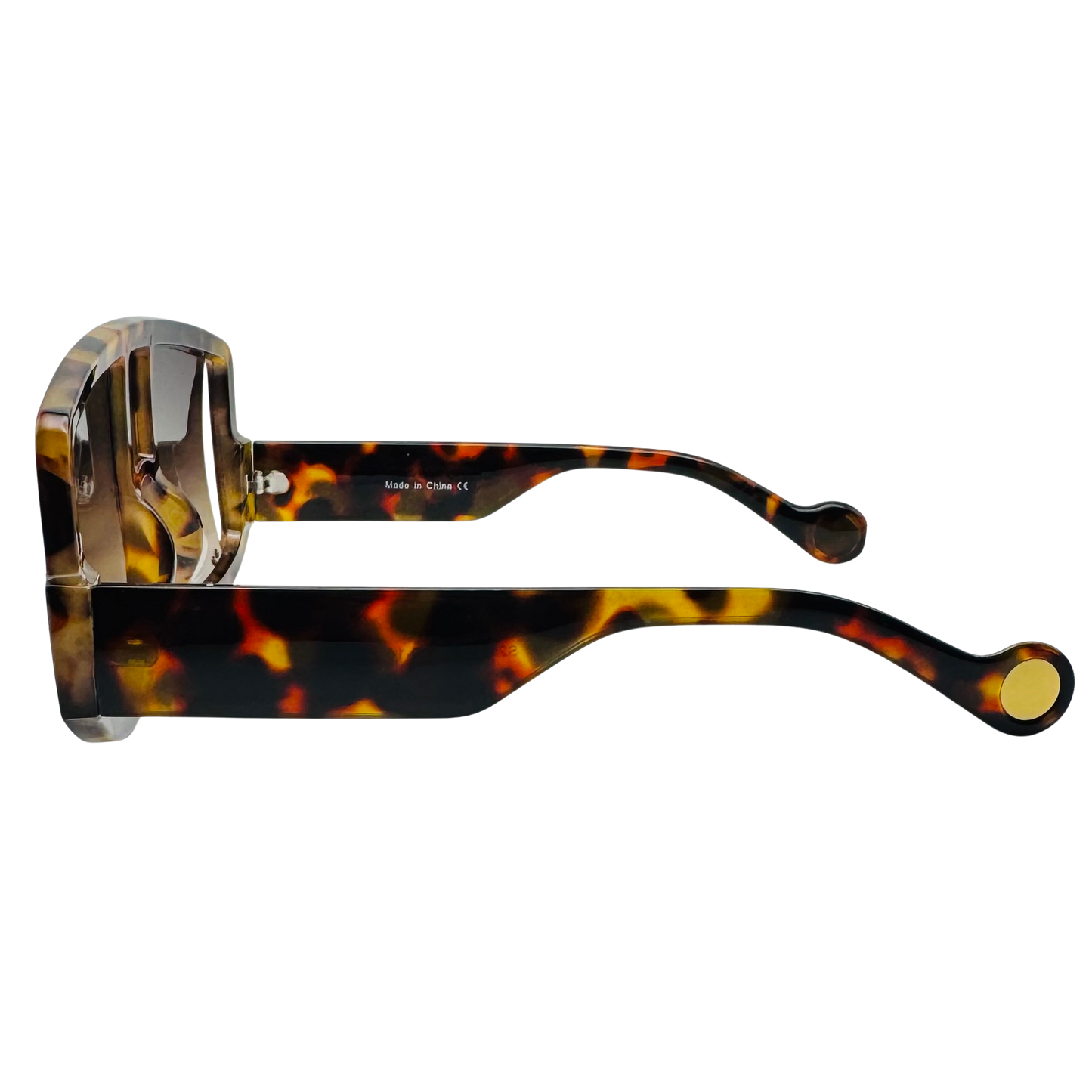 Tortoiseshell sunglasses with gold accents on a white background