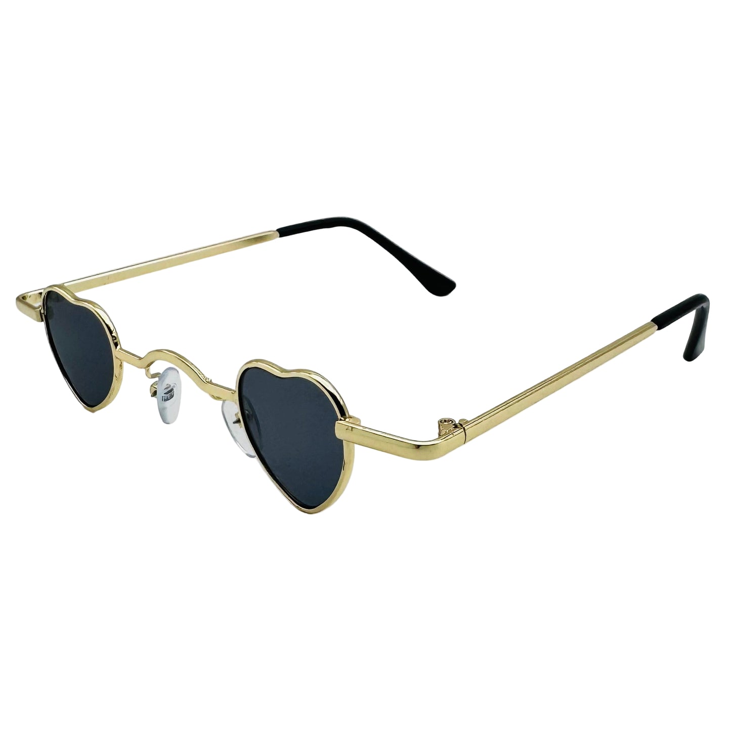 Heart-shaped sunglasses with gold frame and black lenses on a light gray background