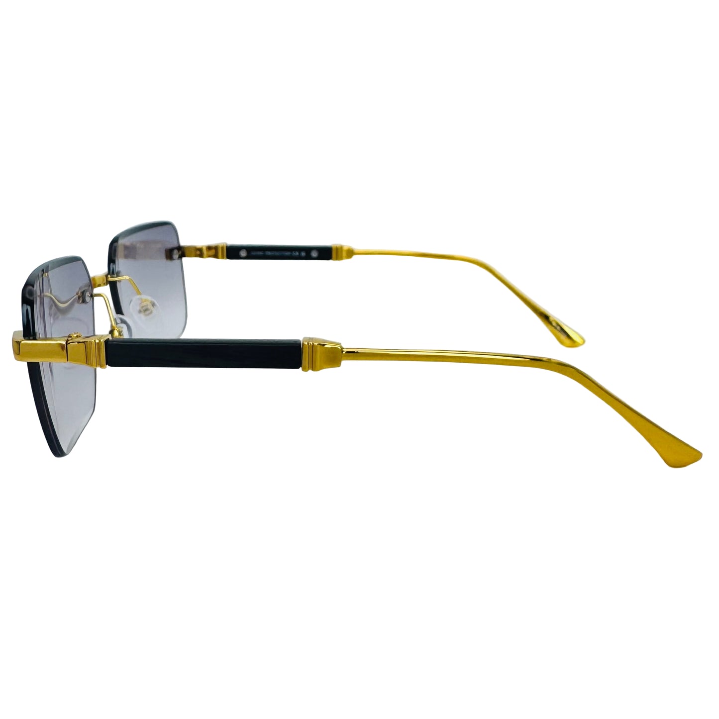 Sunglasses with gold and black frame on a light gray background
