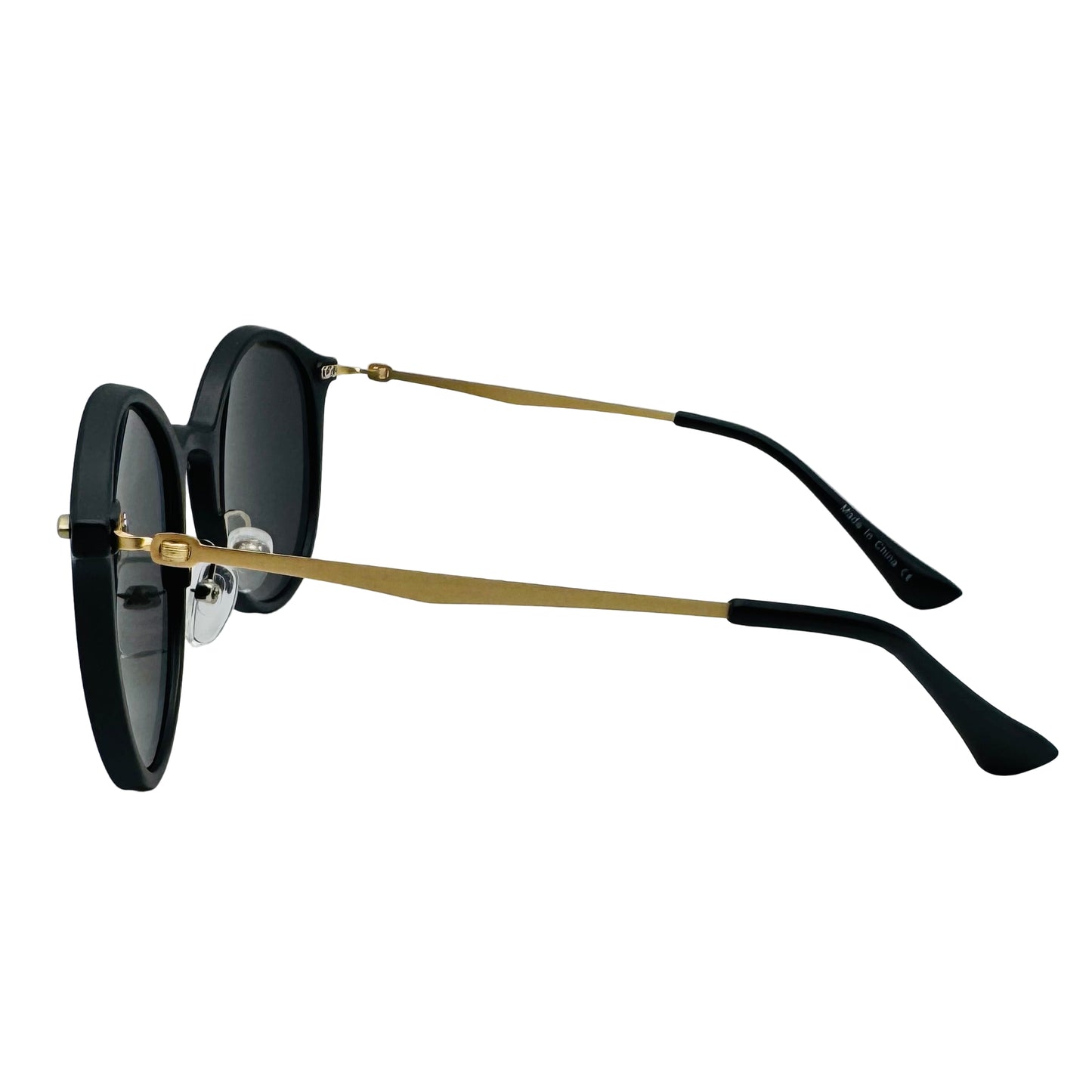 Sunglasses with black lenses and gold frames on a light gray background