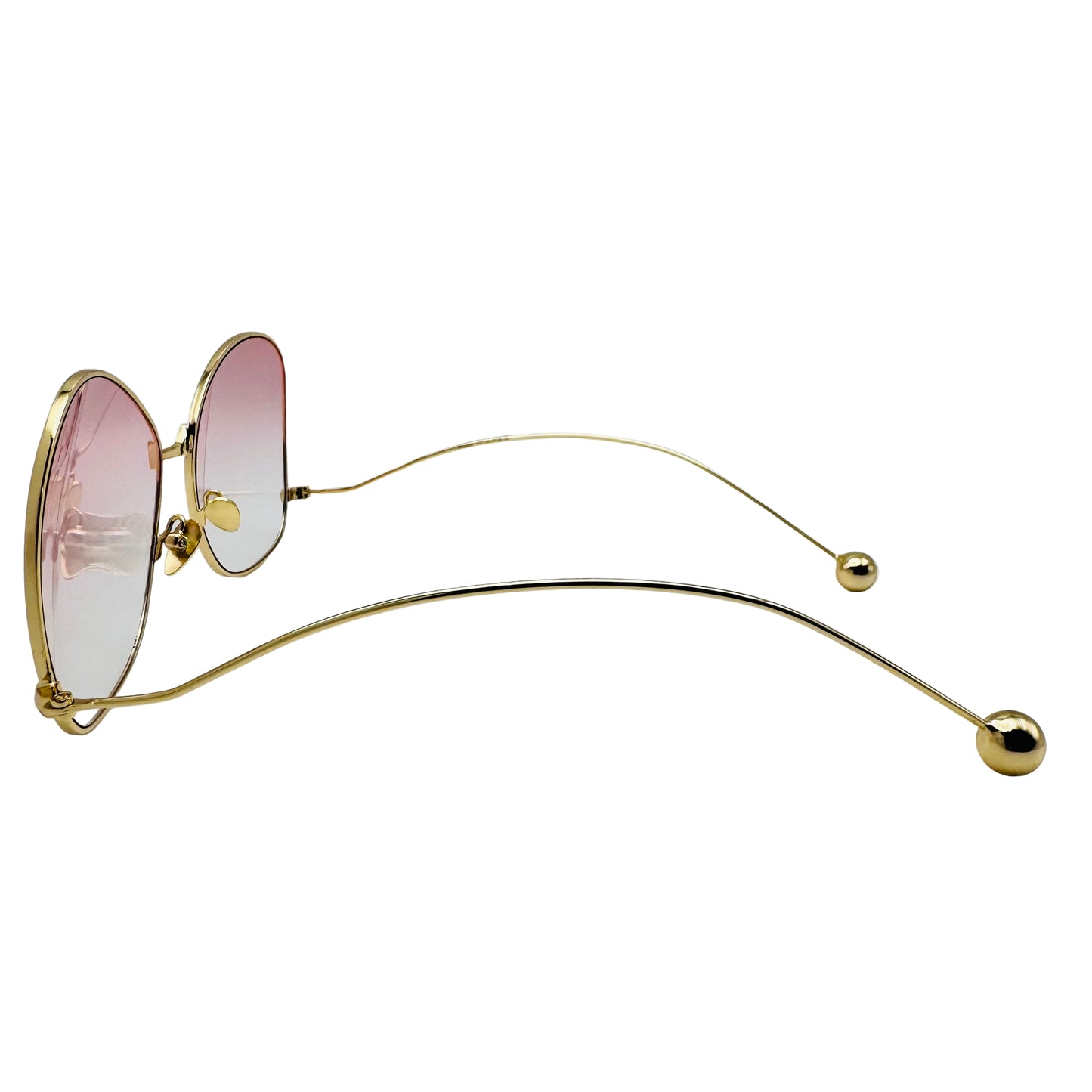 Gold-framed sunglasses with pink lenses on a white background