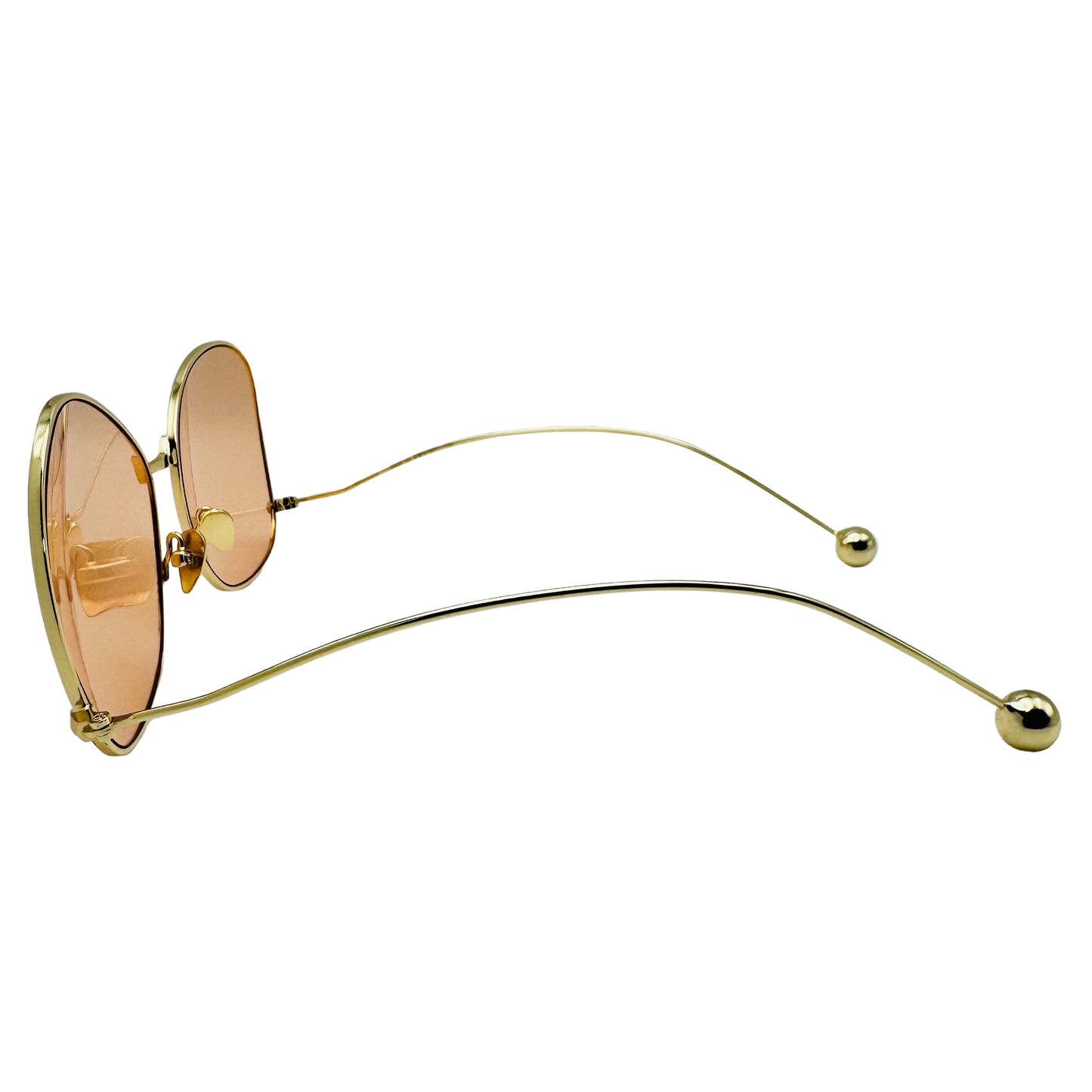 Gold-framed sunglasses with pink lenses on a white background