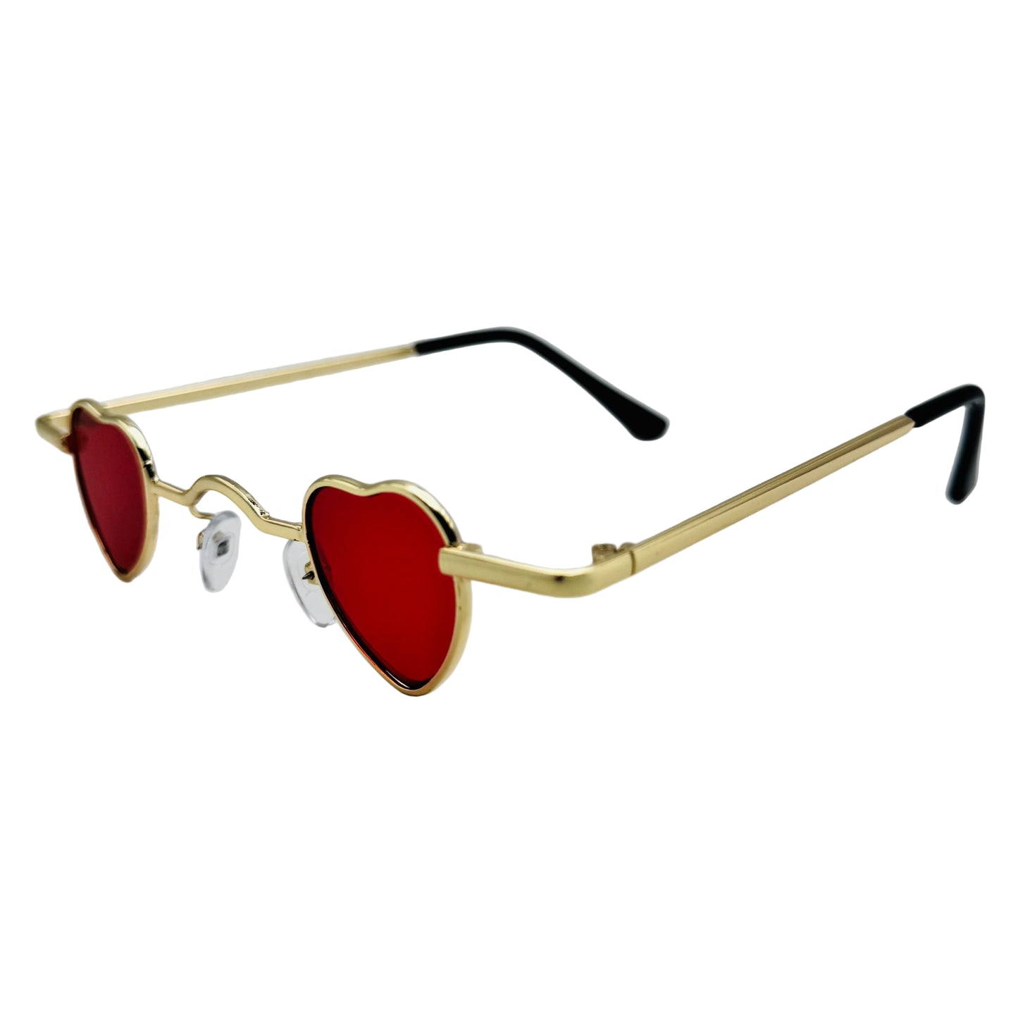 Heart-shaped sunglasses with gold frame and red lenses on a light gray background