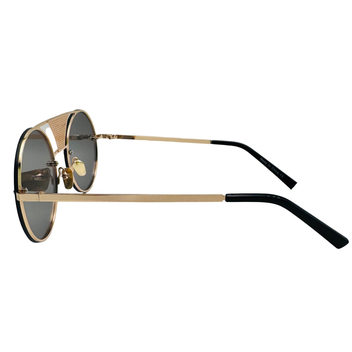 Sunglasses with gold frame and black arms on a light gray background