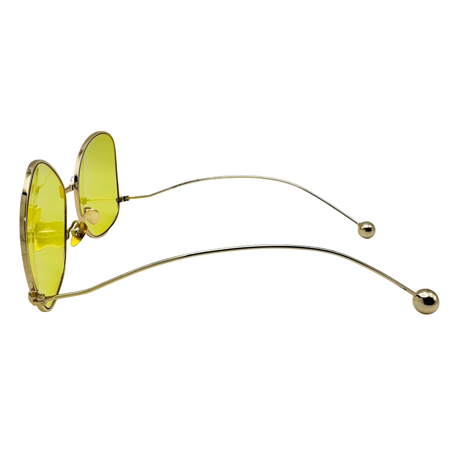 Sunglasses with yellow lenses and gold frames on a white background