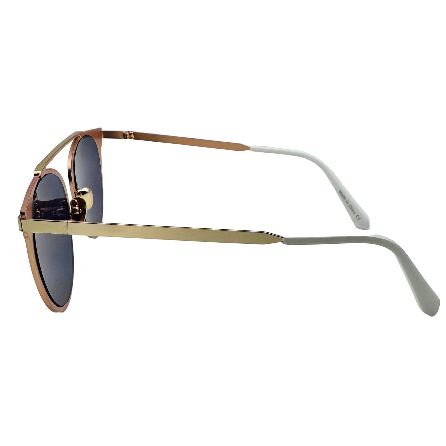 Sunglasses with gold frame and dark lenses on a light gray background