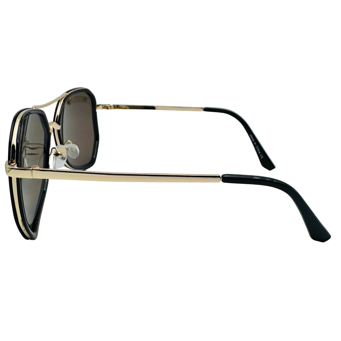 Sunglasses with gold frame and black arms on a light gray background