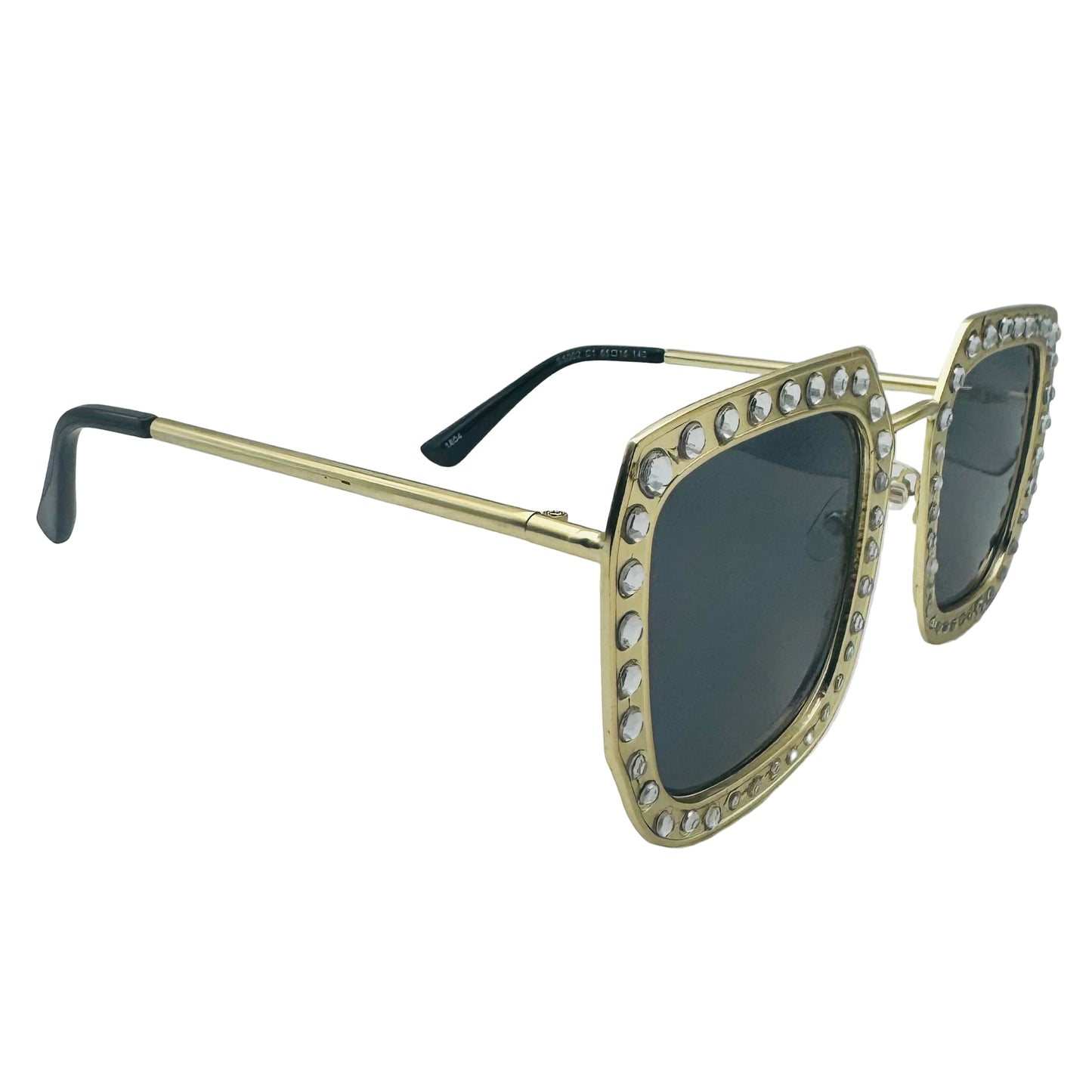 Gold-framed sunglasses with gemstones on a gray background