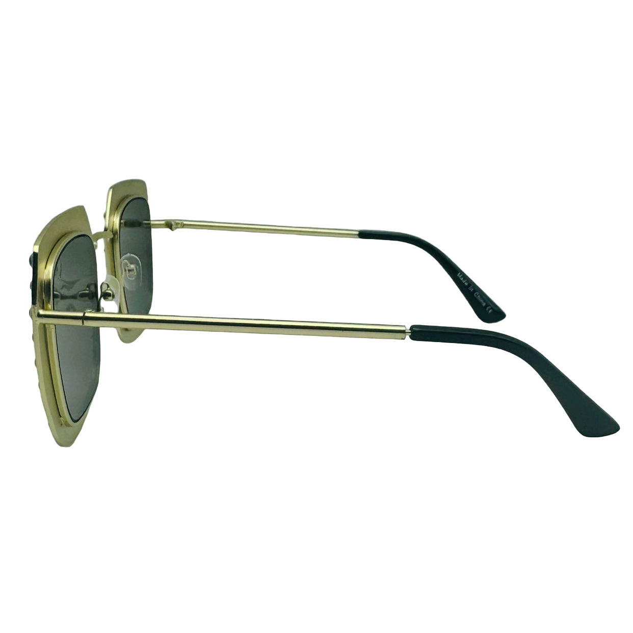 Sunglasses with gold frame and black arms on a light gray background