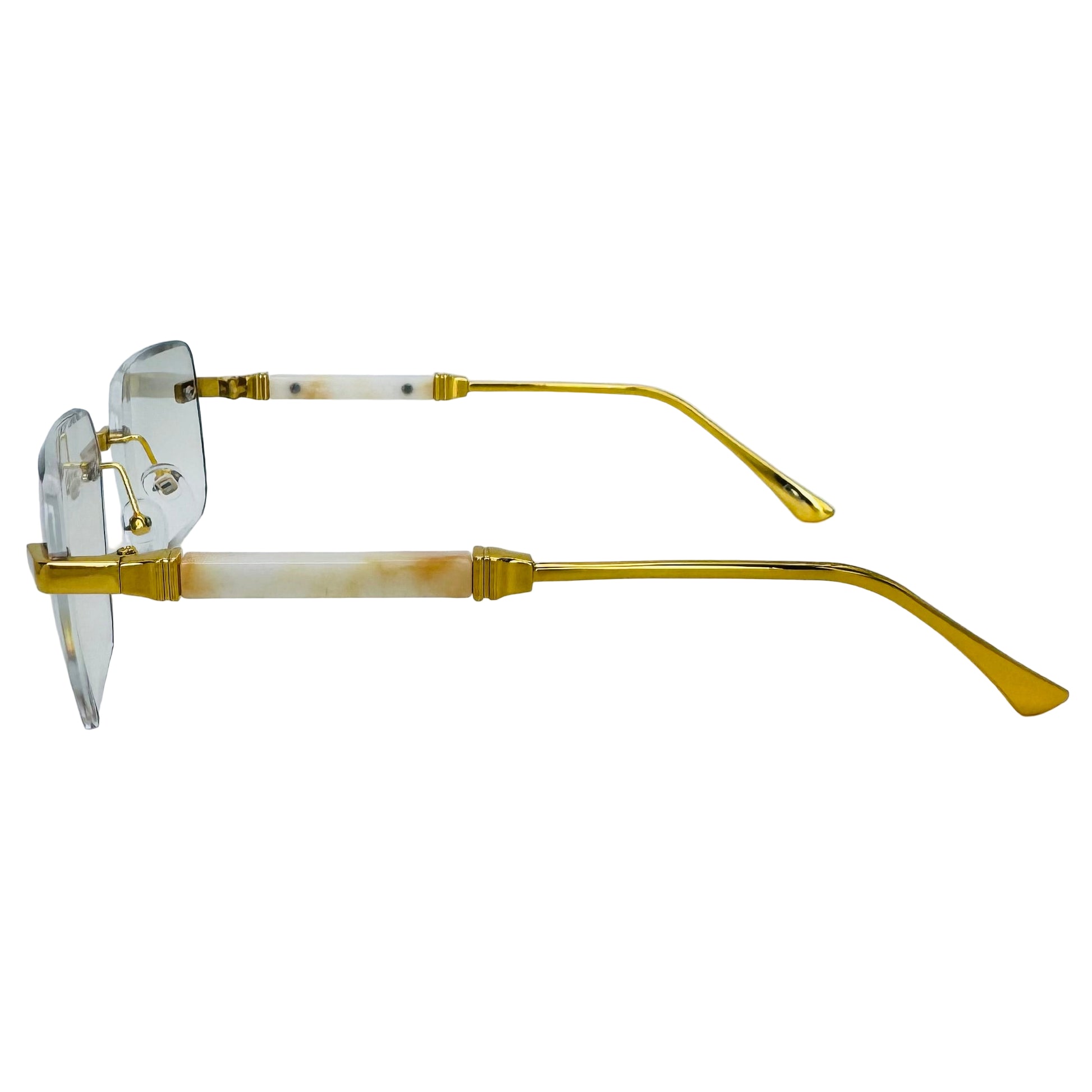 Gold-framed eyeglasses on a light gray background