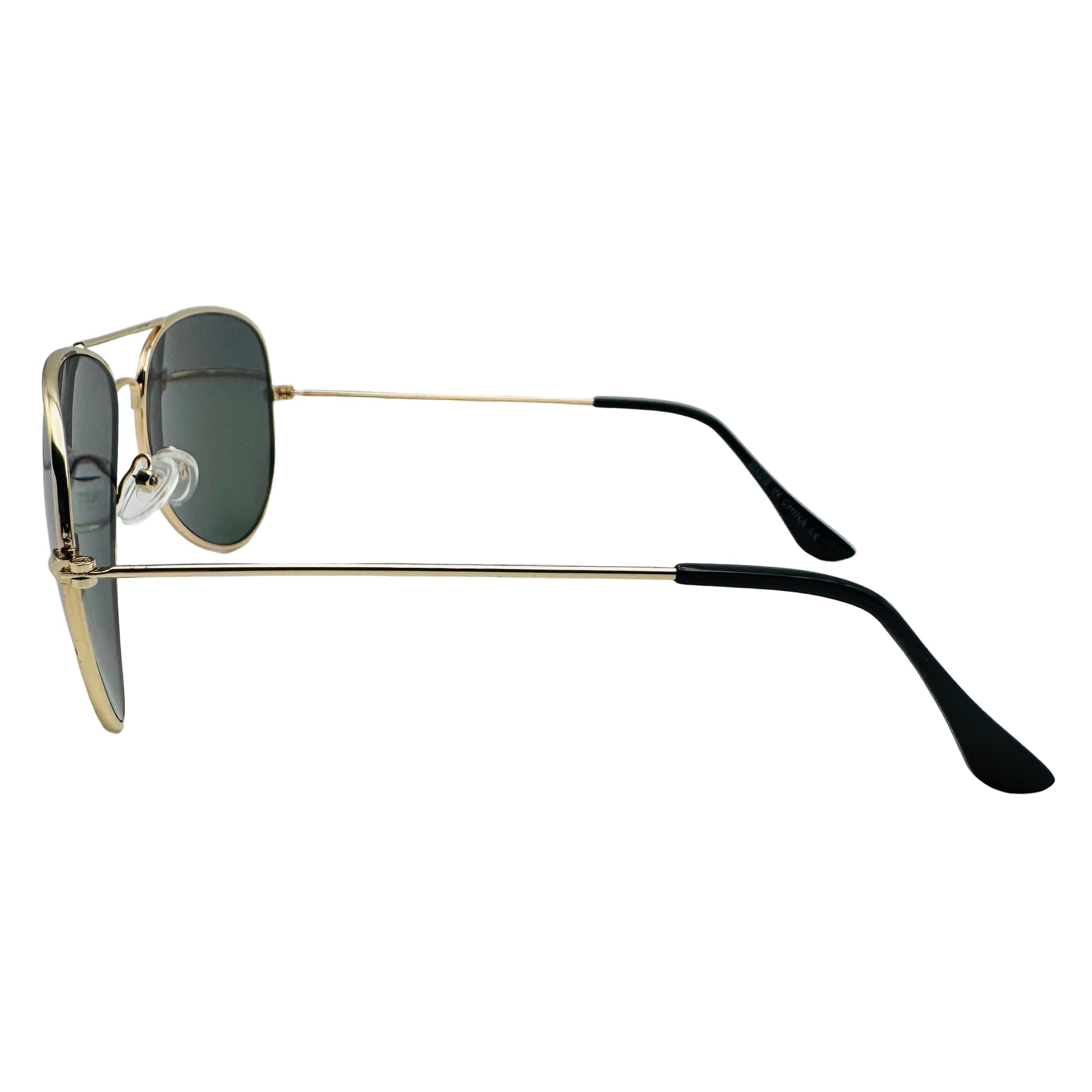 Sunglasses with gold frame and black arms on a light gray background