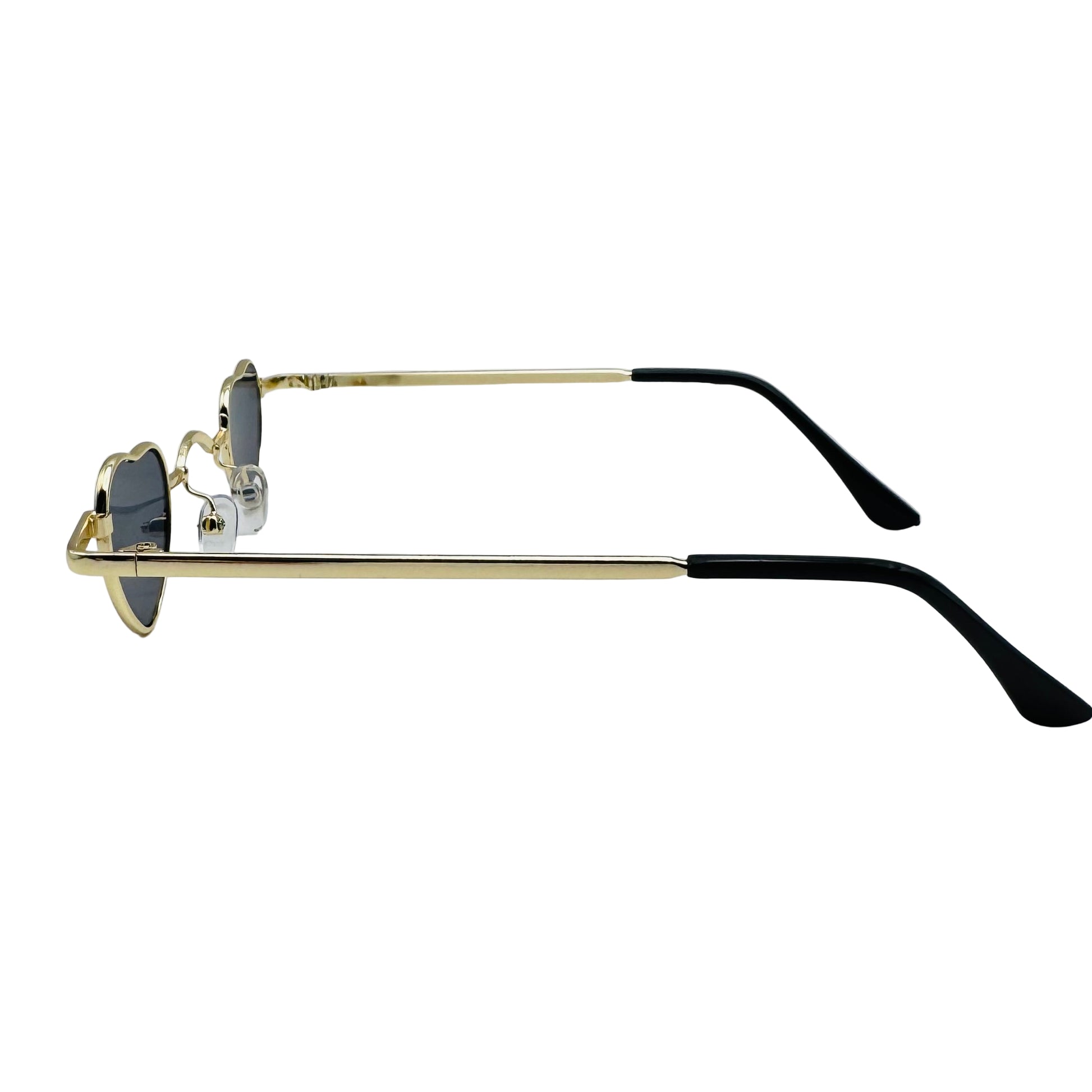 Sunglasses with gold frame and black arms on a light gray background
