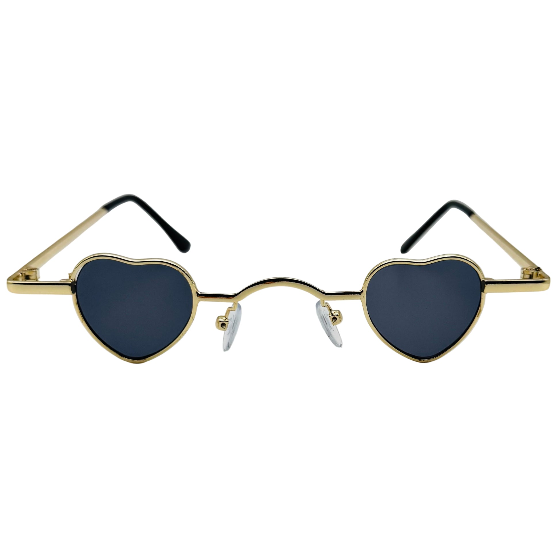 Heart-shaped sunglasses with gold frame and dark lenses on a light gray background