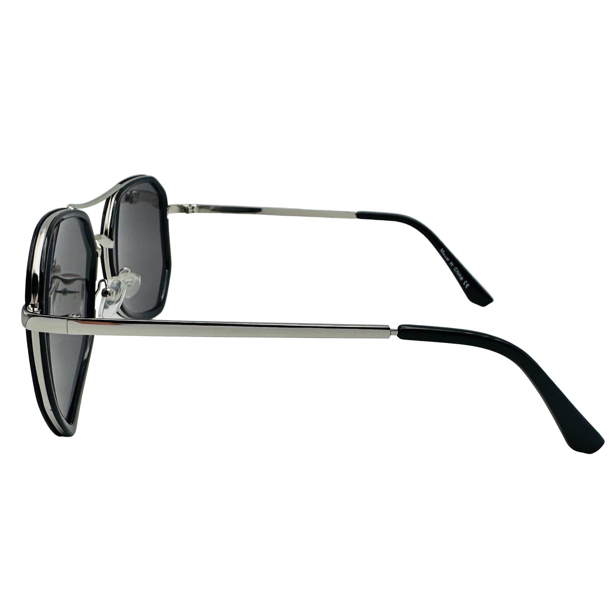 Sunglasses with black lenses and black frames on a light gray background