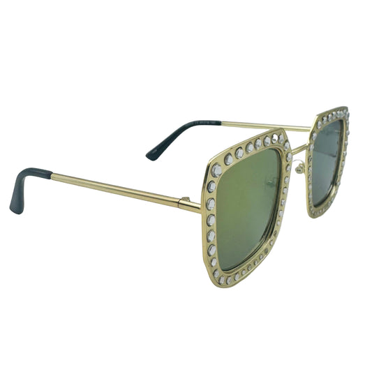 Gold-framed sunglasses with green lenses on a light gray background