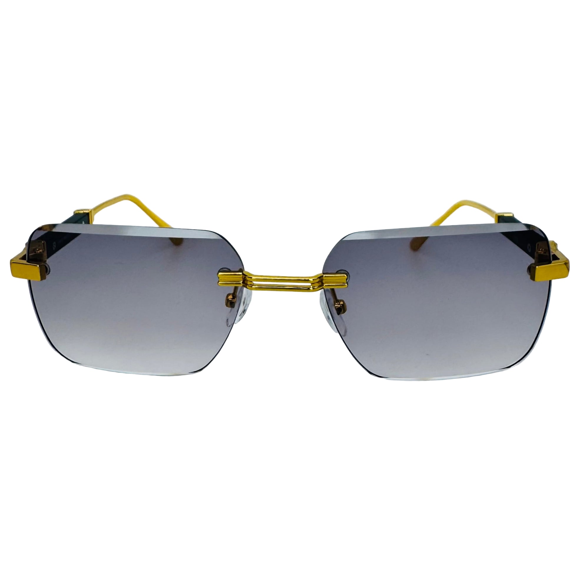 Sunglasses with gold frames and gradient lenses on a light gray background