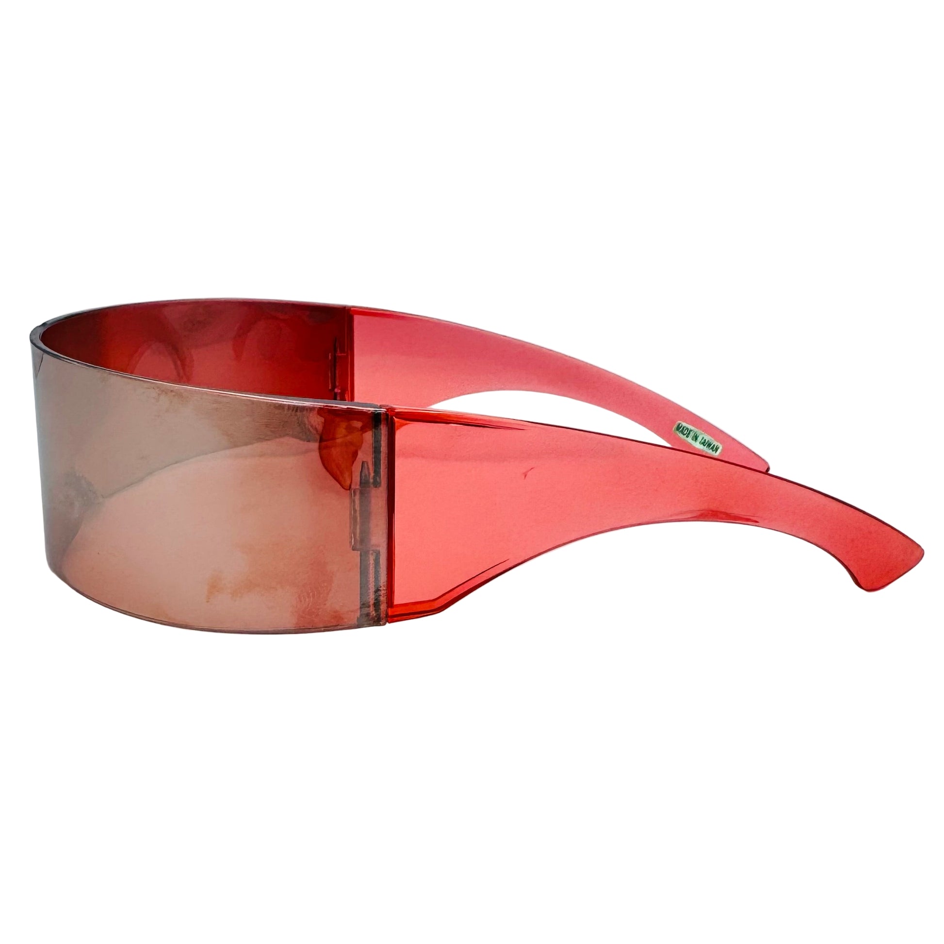 Red sunglasses with a clear lens on a light gray background