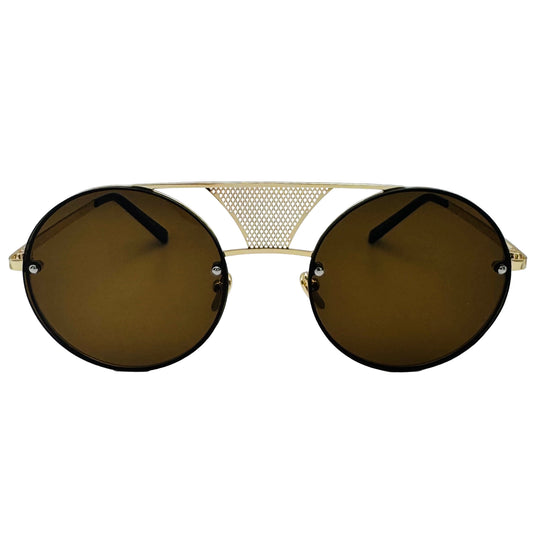 Sunglasses with gold frame and dark lenses on a light gray background