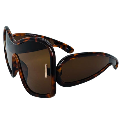 Sunglasses with tortoiseshell frame and brown lenses on a light gray background