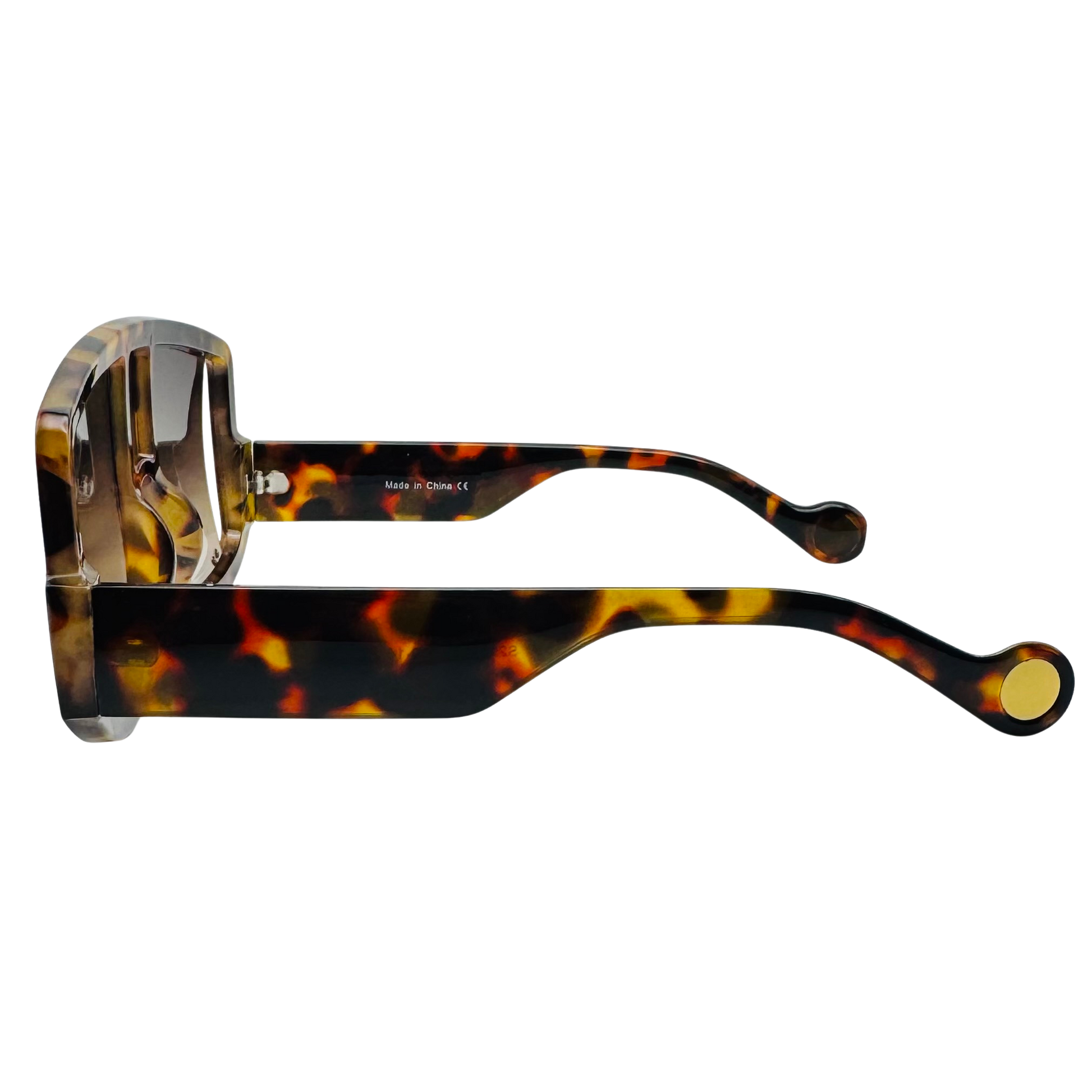 Tortoiseshell sunglasses with gold accents on a white background