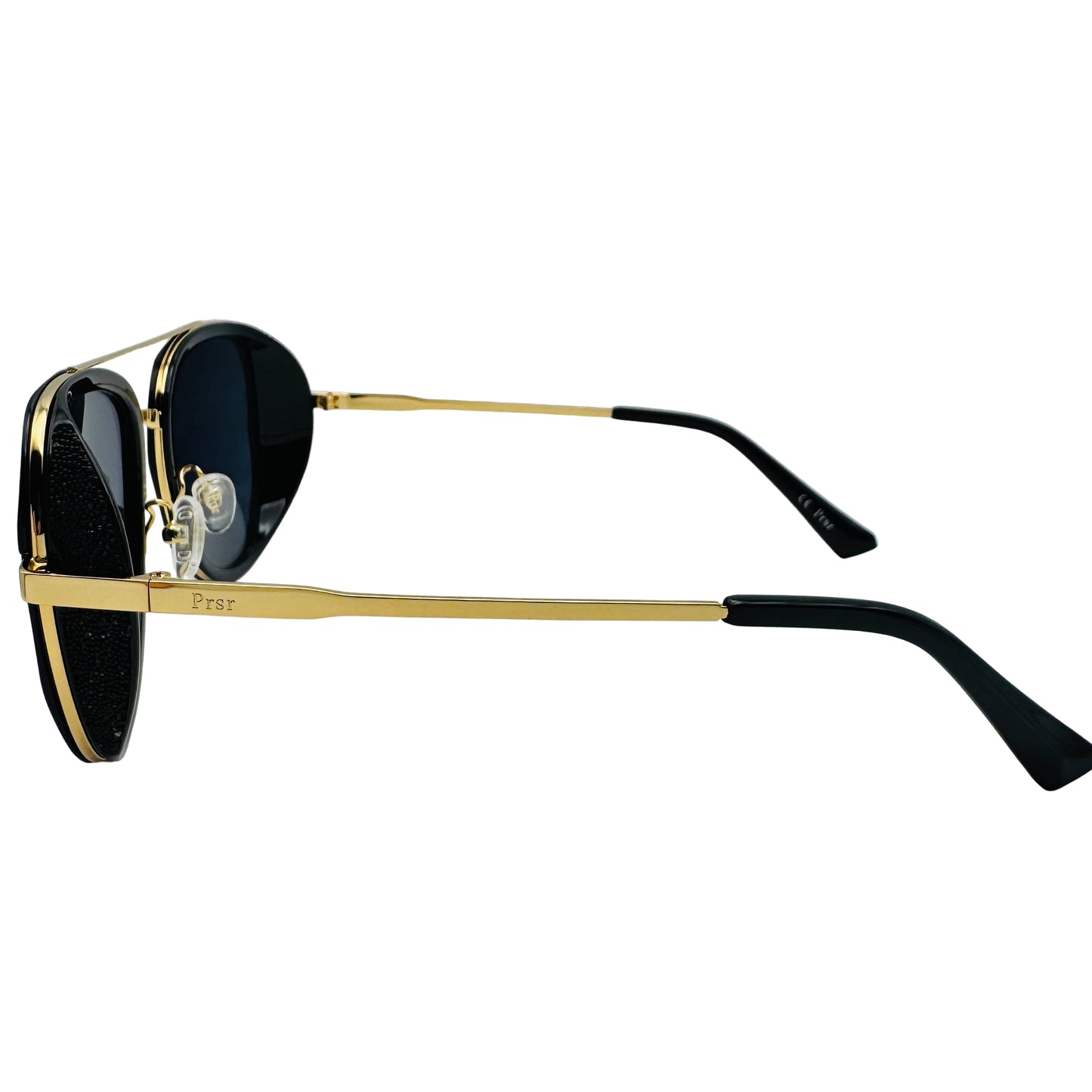 Sunglasses with gold frame and black lenses on a white background