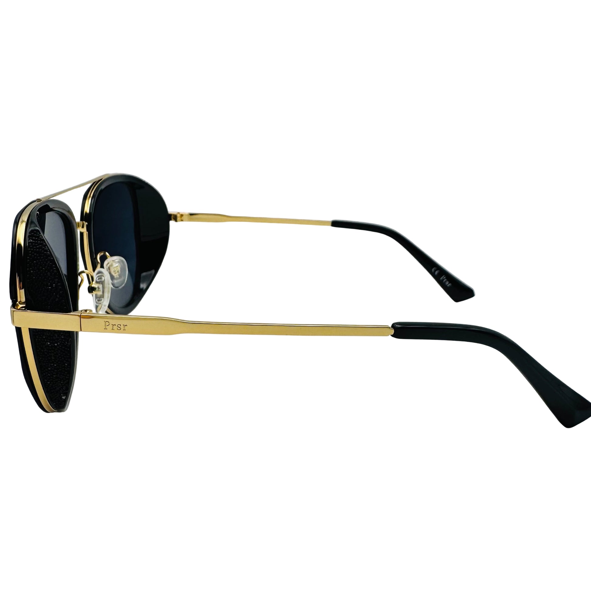 Sunglasses with gold frame and black lenses on a white background