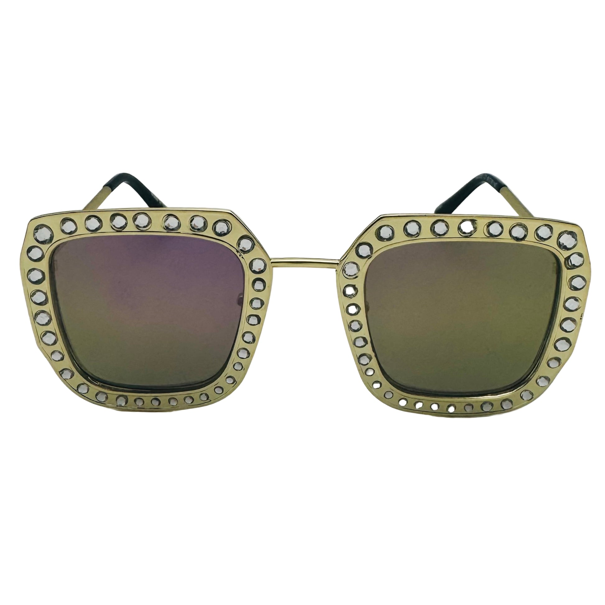 Sunglasses with gold frame and gemstones on a white background