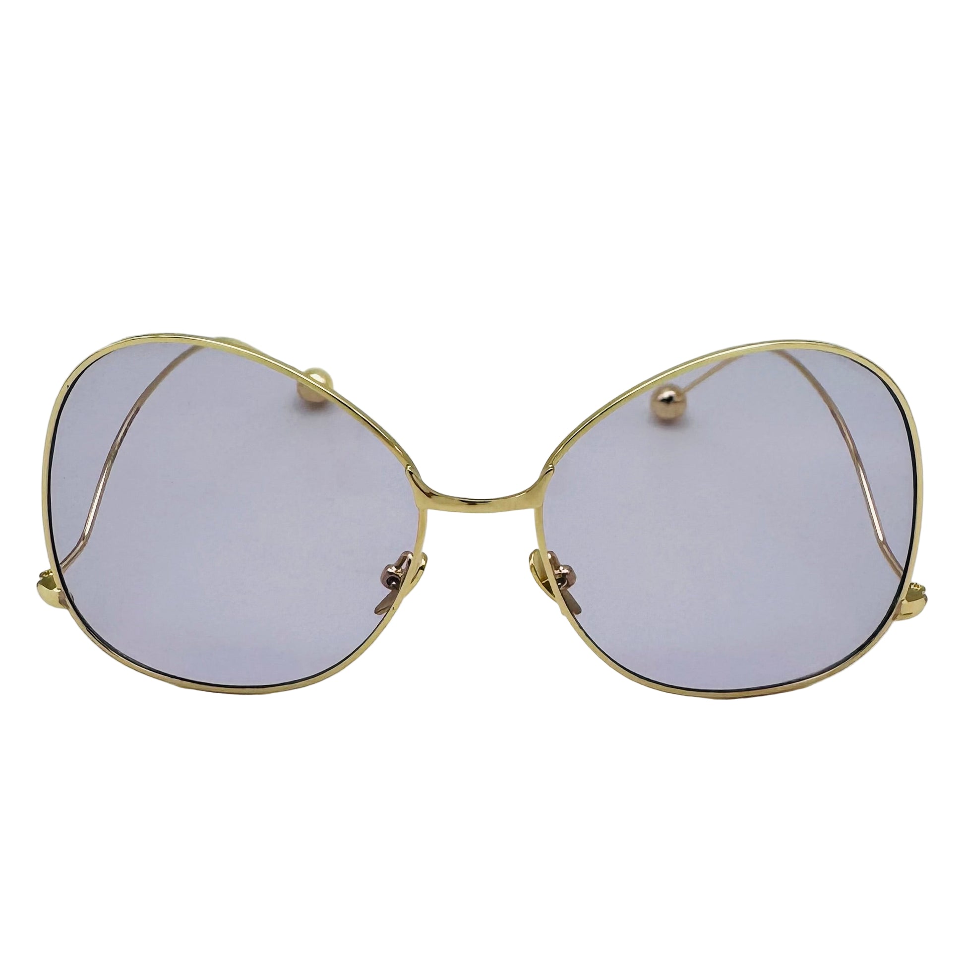 Gold-framed sunglasses with purple lenses on a white background
