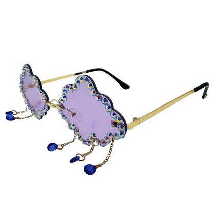 Sunglasses with purple lenses and gold frame on a white background