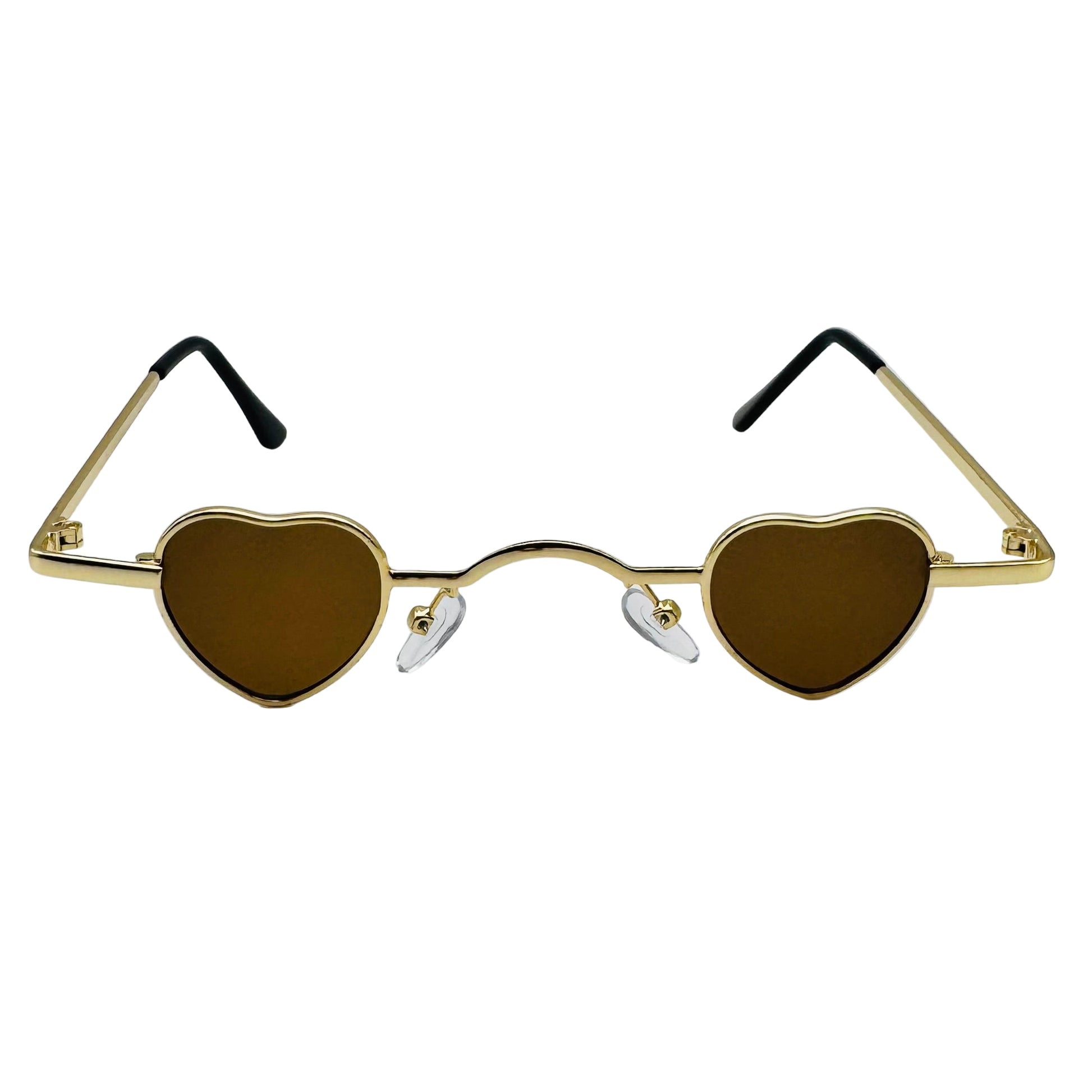 Heart-shaped sunglasses with gold frames and brown lenses on a light gray background