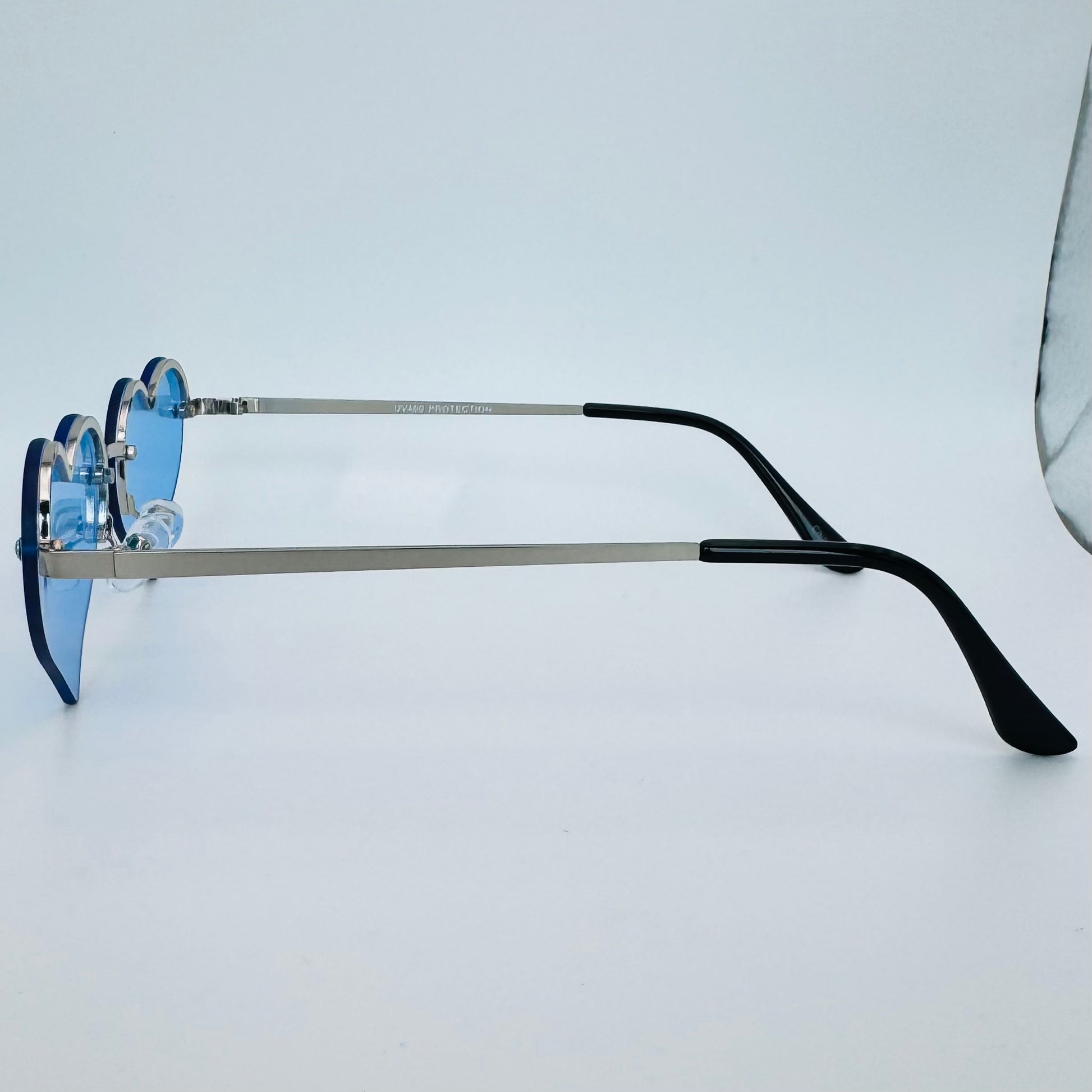 Eyeglasses with blue lenses and black arms on a light gray background