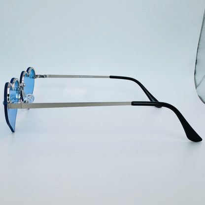 Eyeglasses with blue lenses and black arms on a light gray background