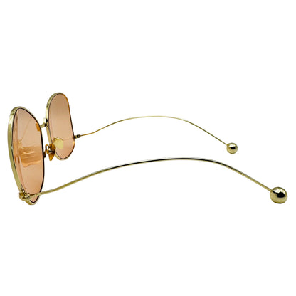 Gold-framed sunglasses with pink lenses on a white background