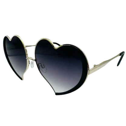 Heart-shaped sunglasses with black lenses and gold frames on a white background