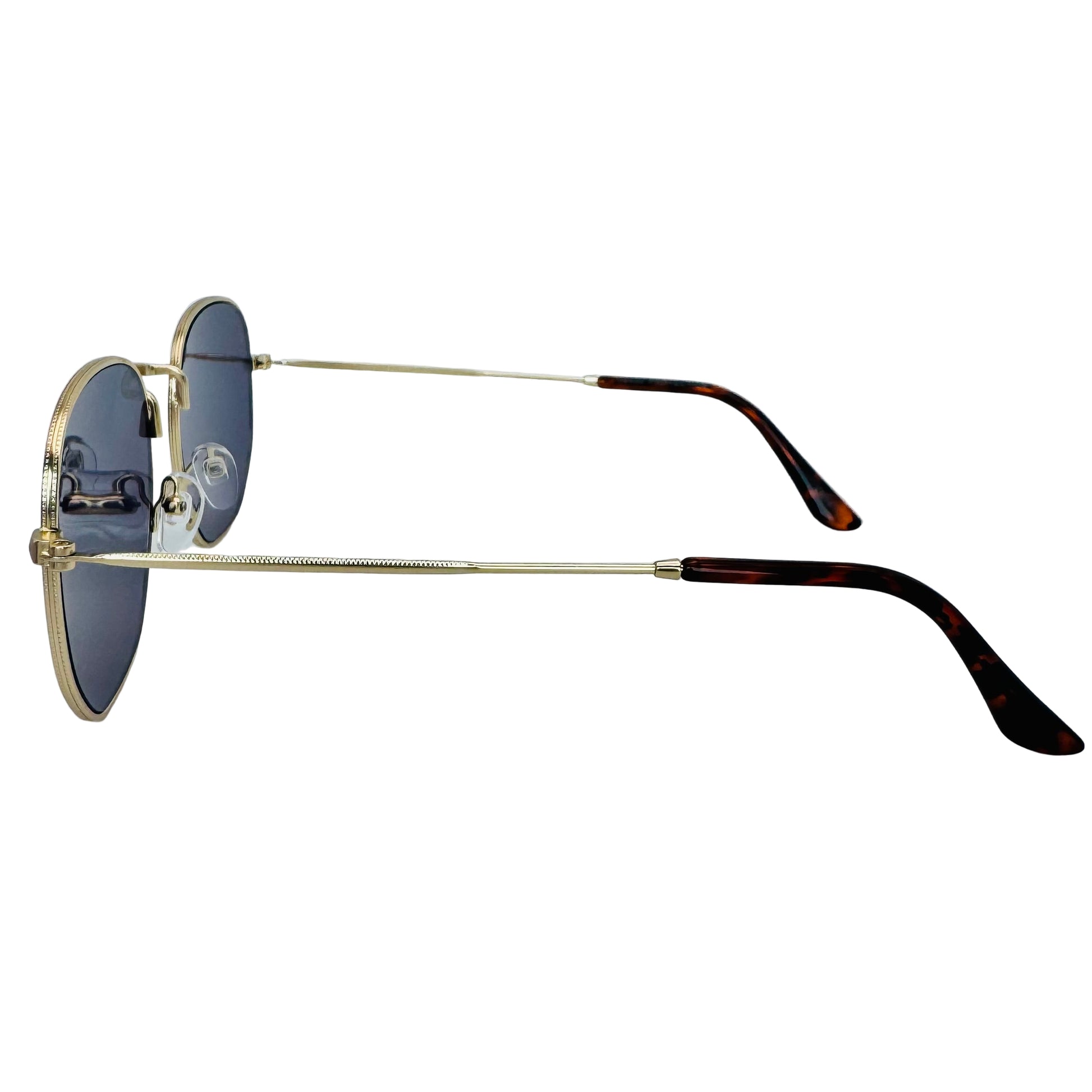 Sunglasses with gold frame and tortoiseshell arms on a light gray background