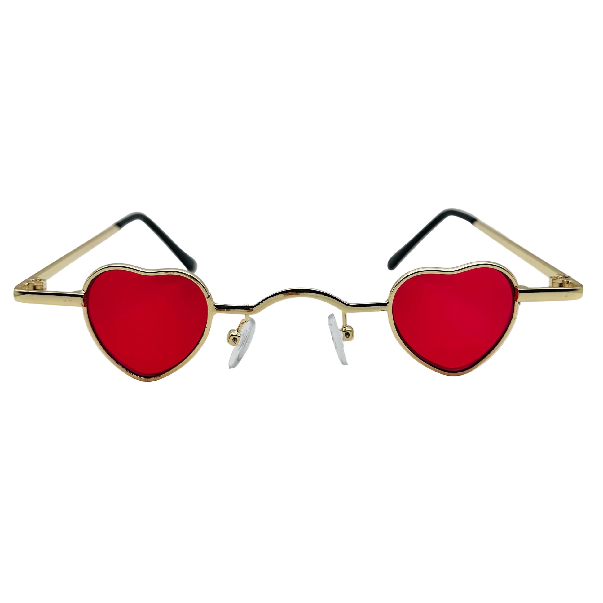 Heart-shaped sunglasses with red lenses and gold frames on a light gray background