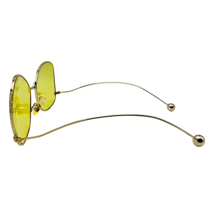 Sunglasses with yellow lenses and gold frames on a white background