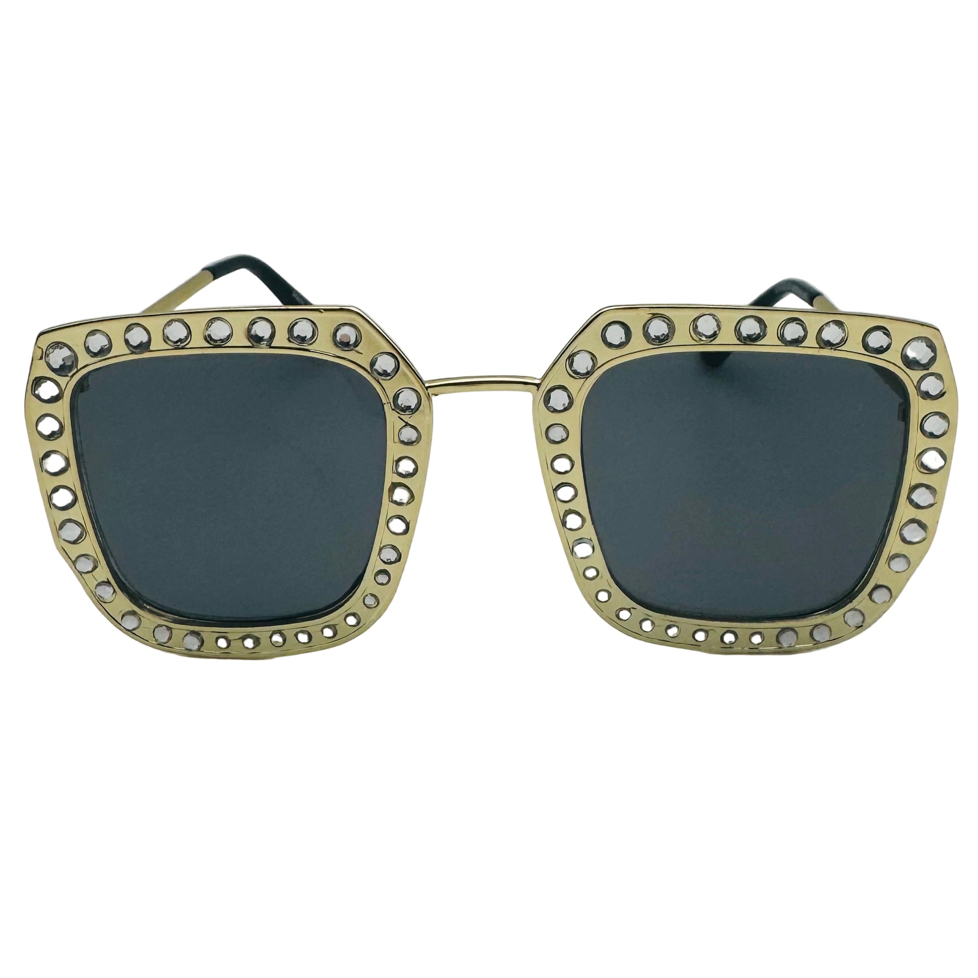 Sunglasses with gold frame and gemstones on a white background