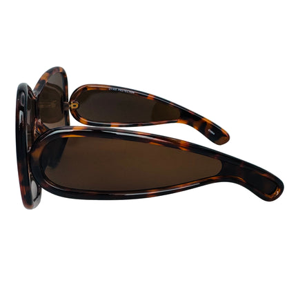 Sunglasses with tortoiseshell frame and dark lenses on a light gray background