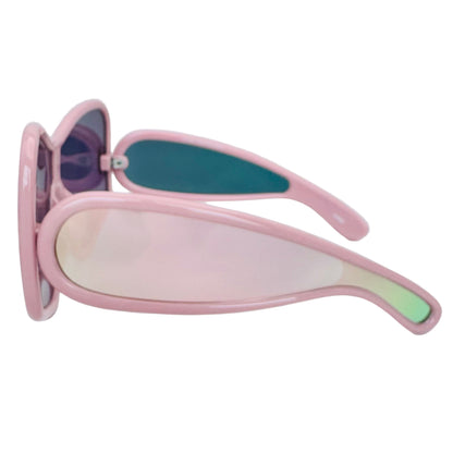 Pink sunglasses with a reflective lens held by a hand on a white background