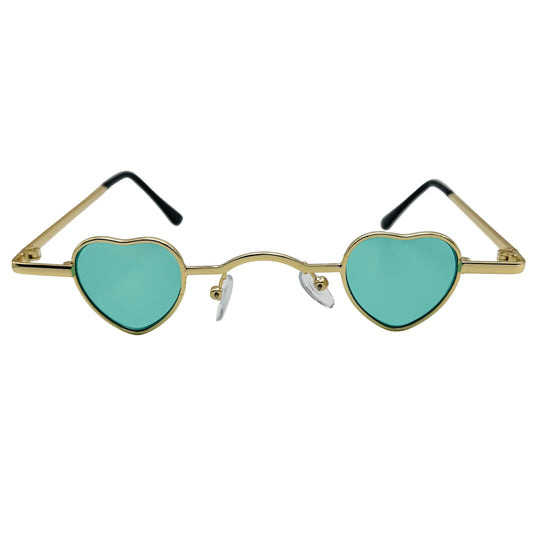 Heart-shaped sunglasses with gold frame and turquoise lenses on a light gray background