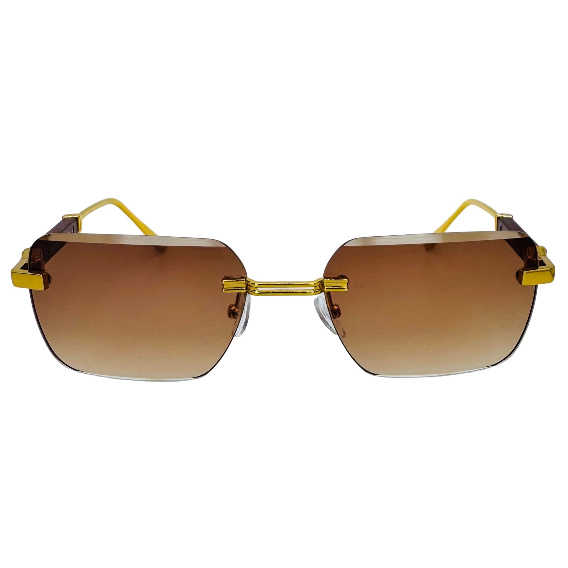 Sunglasses with gold frame and brown lenses on a light gray background