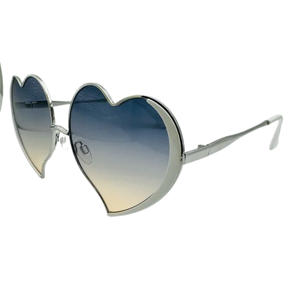 Heart-shaped sunglasses with gradient lenses on a white background