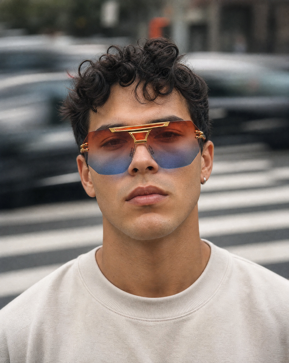 Model wearing the 5009 Skyline flat-top shield sunglasses in Red/Blue, showing the single beveled hexagonal lens with orange to blue gradient and gold brow bar