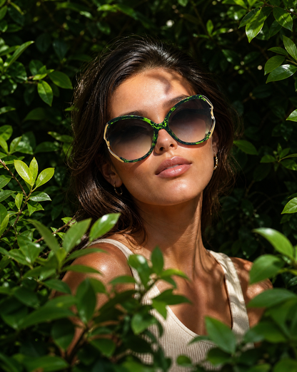 Model wearing the 5011 Lovestruck oversize butterfly sunglasses in Green Multi, showing the marbled green acetate frame, smoke gradient lenses, and gold cutout temple arms